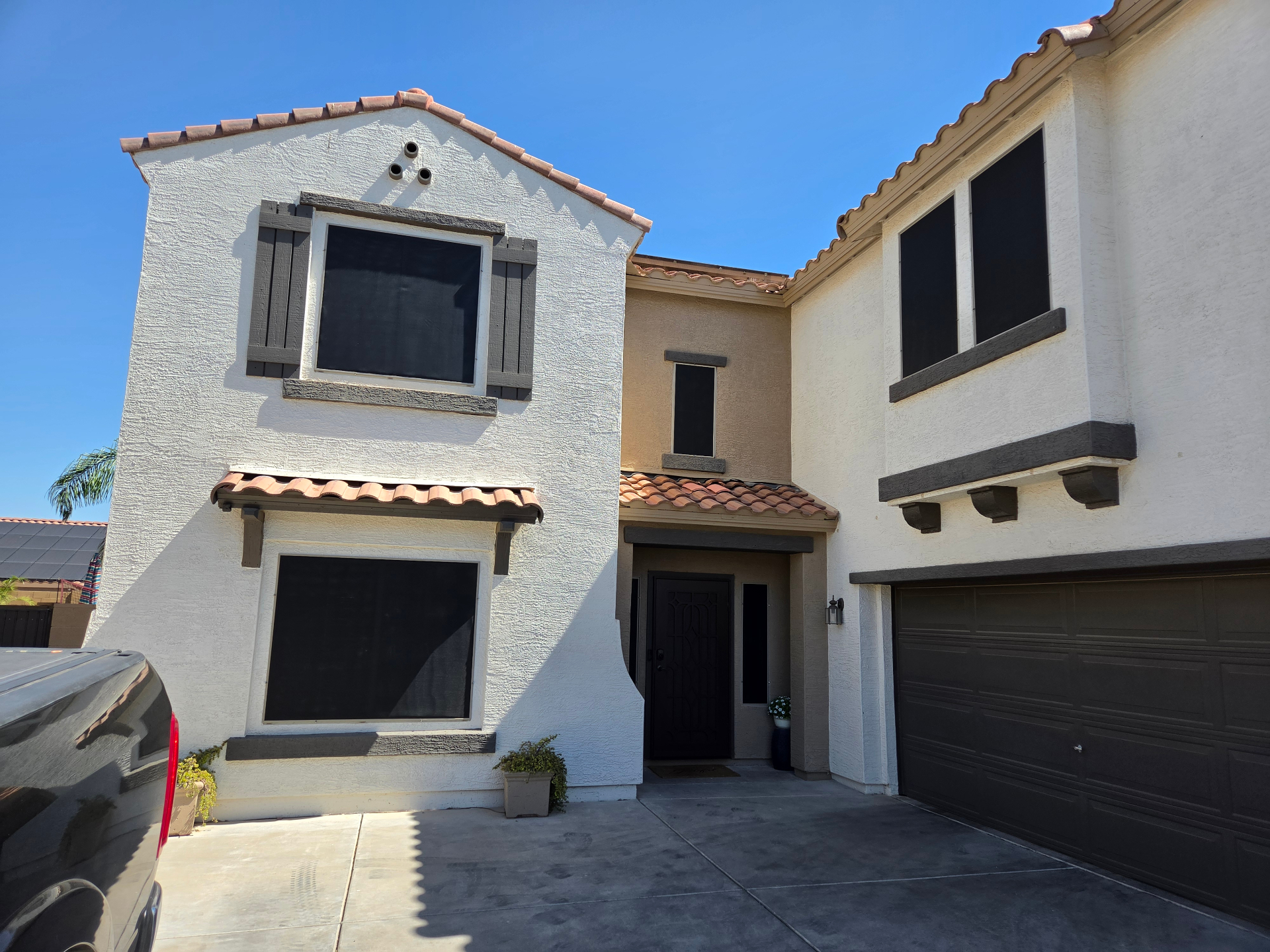 Two-story home with sun screens on every window